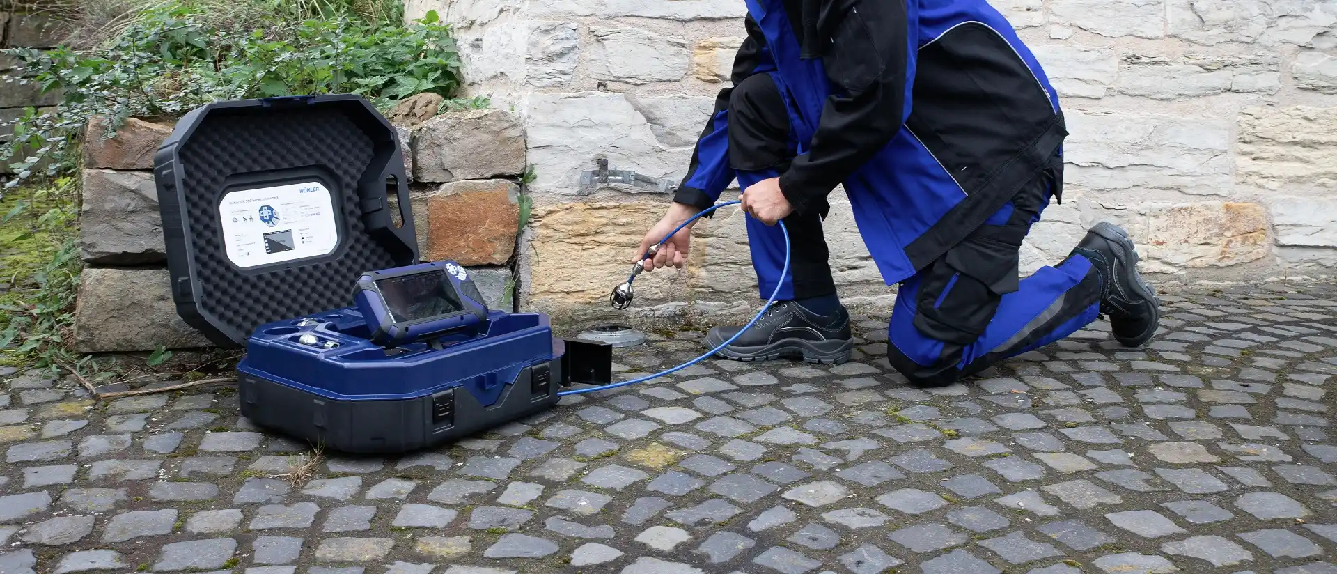 Ein Mann, der denn Dreck mit dem Entfernungsgerät wegspritzt